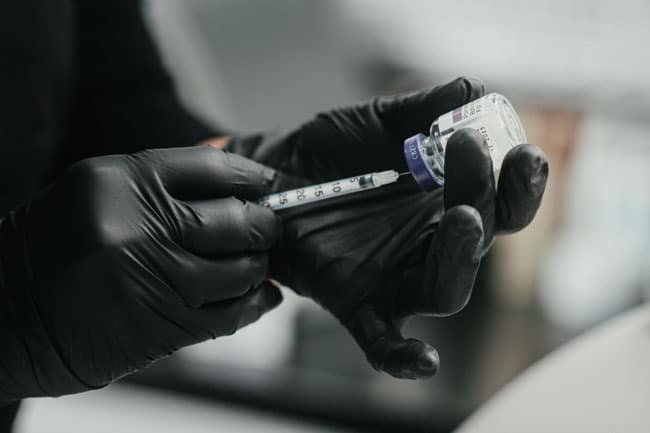 Dr. Lauren fills her syringe with facial fillers to be used to inject her patients.