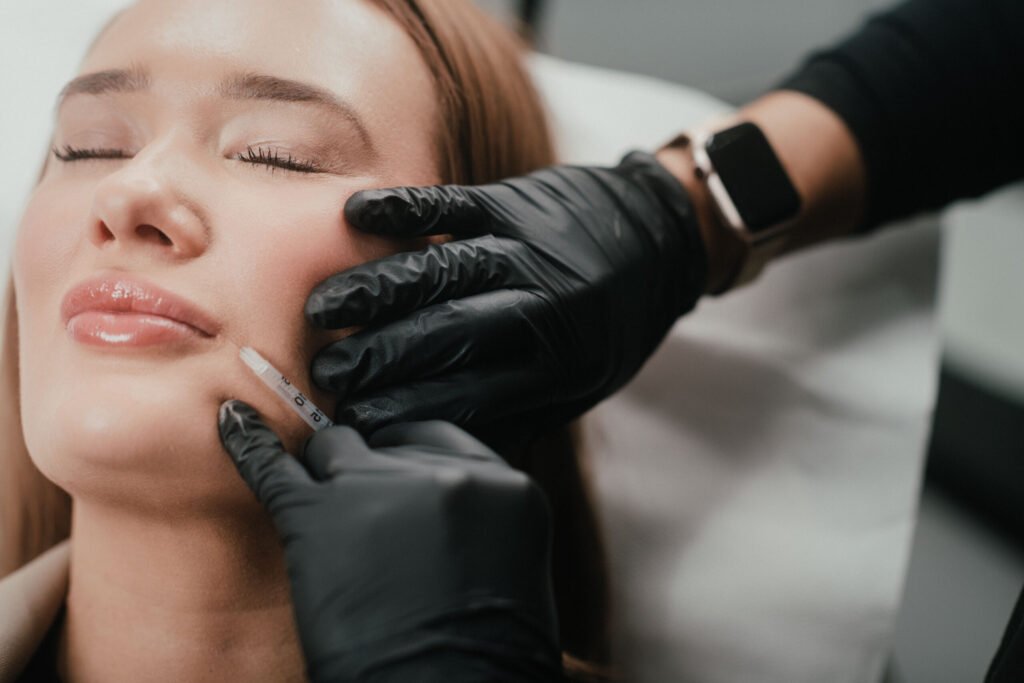 Dr. Lauren injects botox into one of her patient's lips to increase her lips' volume.