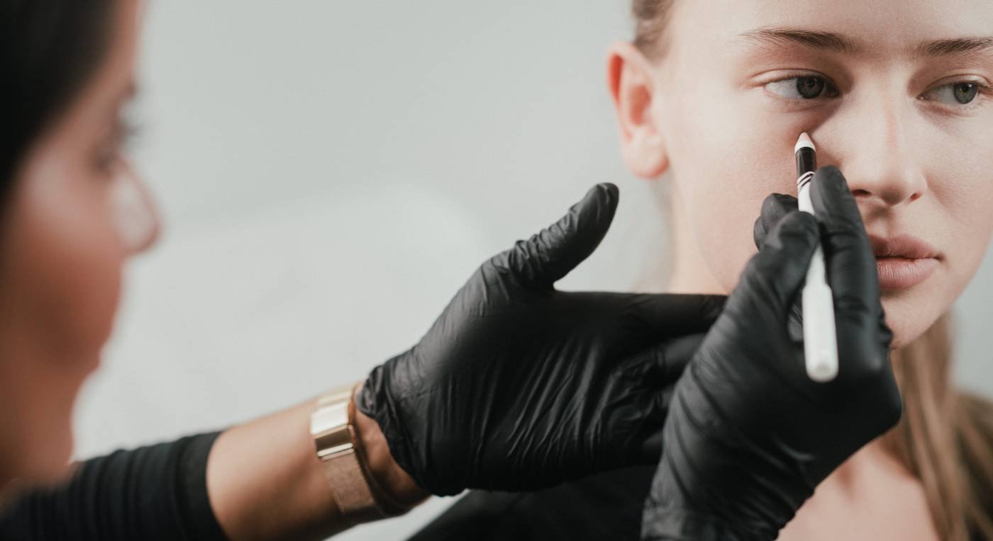 Dr. Lauren marks areas of her patient's face suitable for an anti-wrinkle treatment.