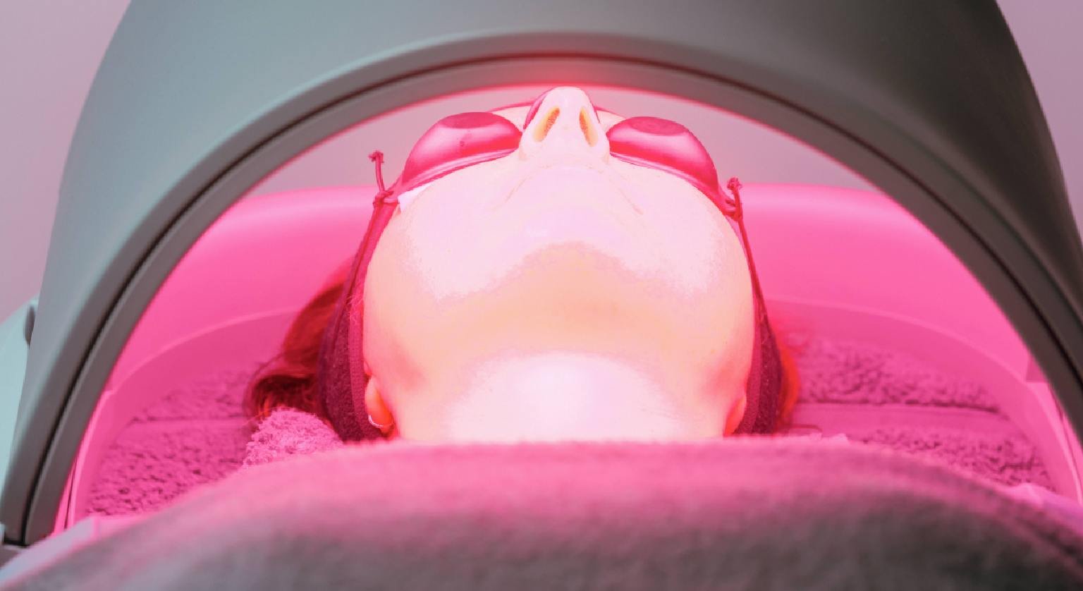 A patient getting Dermalux LED-light treatment.