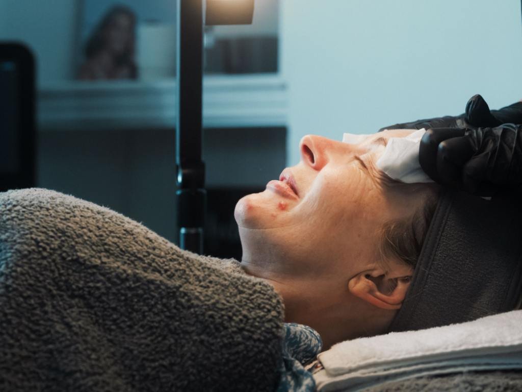A patient satisfied while getting a medical grade skin treatment done.