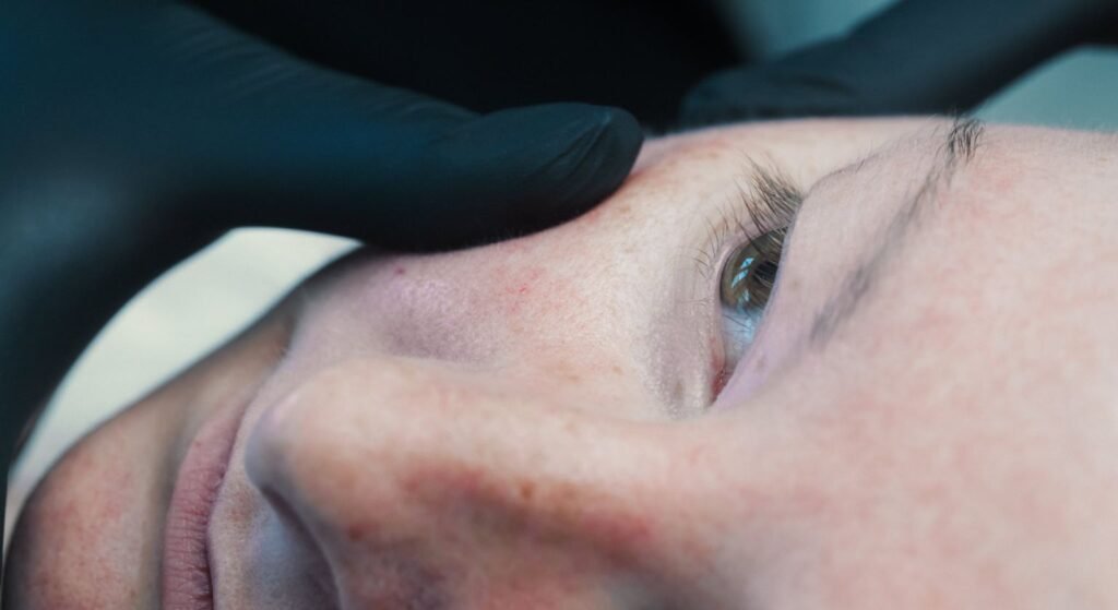 Dr. Lauren assessing a patient's skin for the best rosacea treatment.