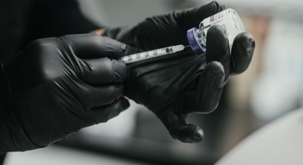 Dr. Lauren prepping a syringe with dermal filler to be used on a patient.