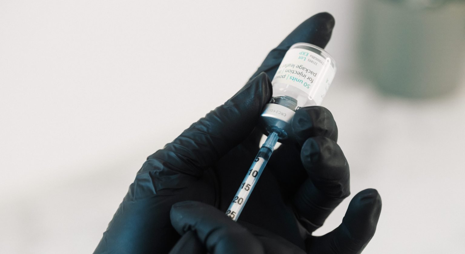 Dr. Lauren prepping a syringe with Botulinum toxin to be used on a patient.