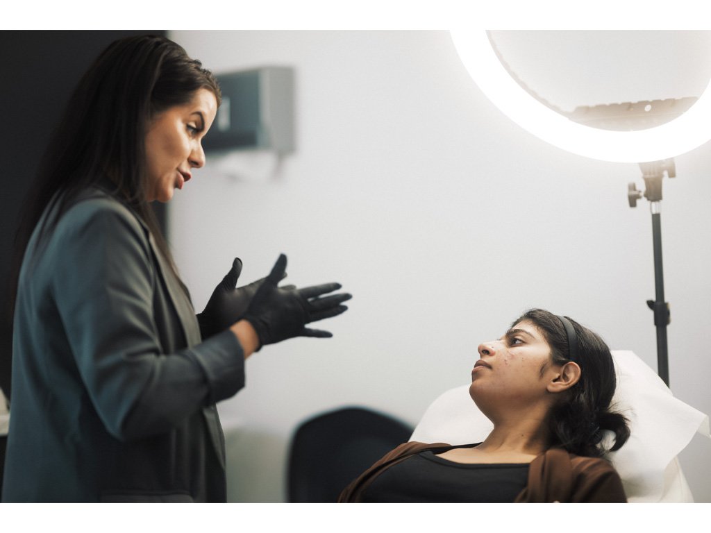 Dr. Lauren consulting with a patient as to which skin treatment will be the most beneficial for her.
