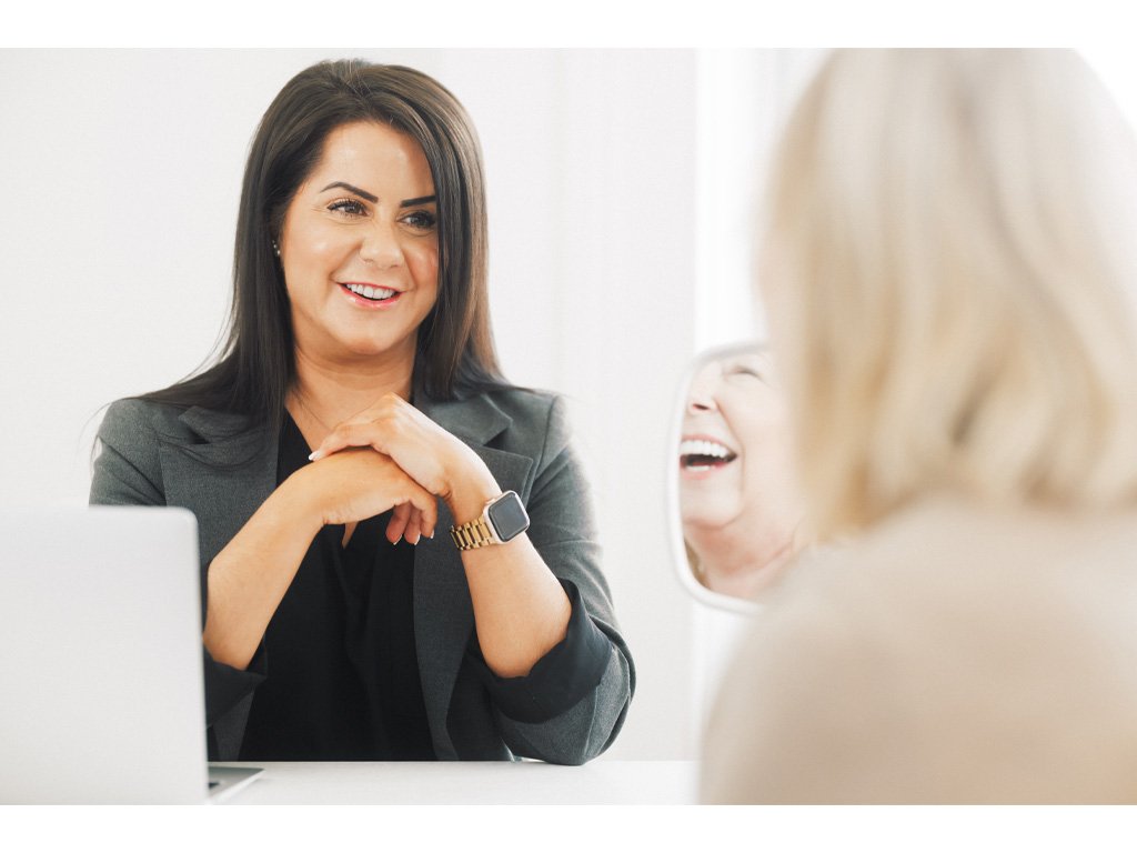 Dr Lauren consulting with and guiding a patient about her treatment plan for lip fillers.