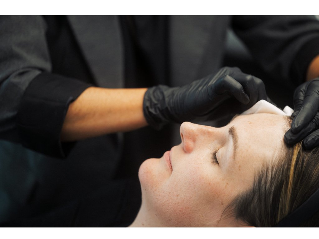 Dr. Lauren preparing a patient's face for treatment.