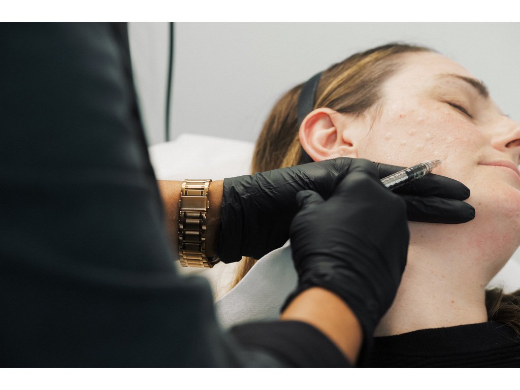 Dr. Lauren injecting a patient's face.