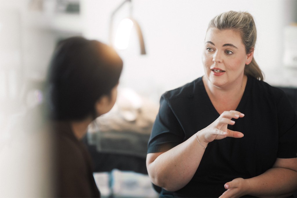 A Skin Therapist at Dr Lauren’s clinic consulting with a patient and guiding her toward the most suitable treatment pathway.