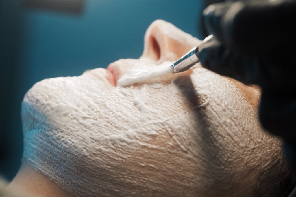 A patient receiving a HydroPeptide-based facial treatment.