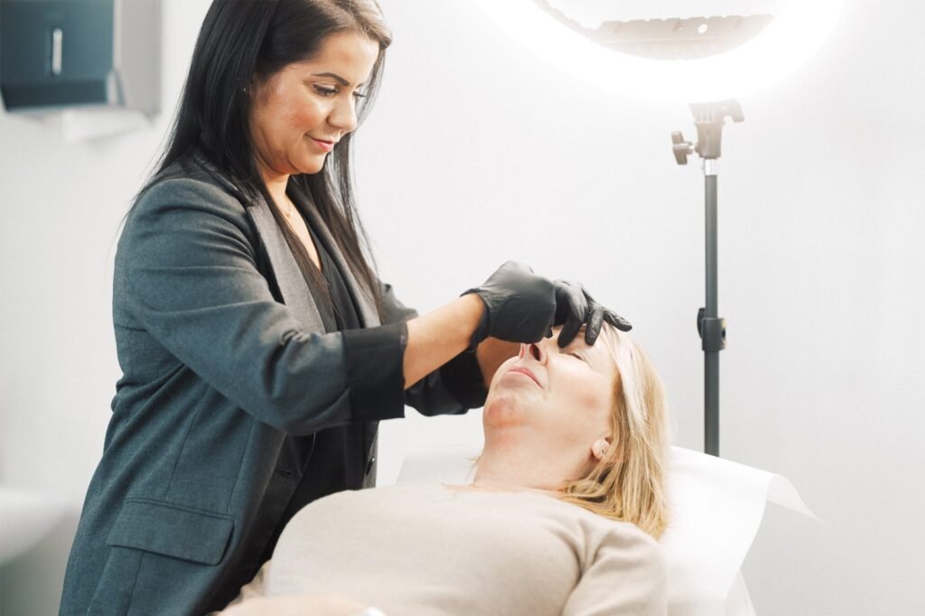 Dr Lauren injecting a patient's face with anti-wrinkle treatment.