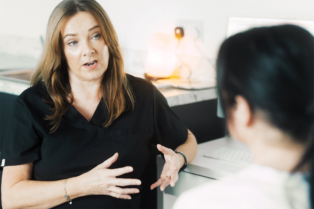 Skin Therapist Lynn Brown guiding a patient about the appropriate skin care for spring.