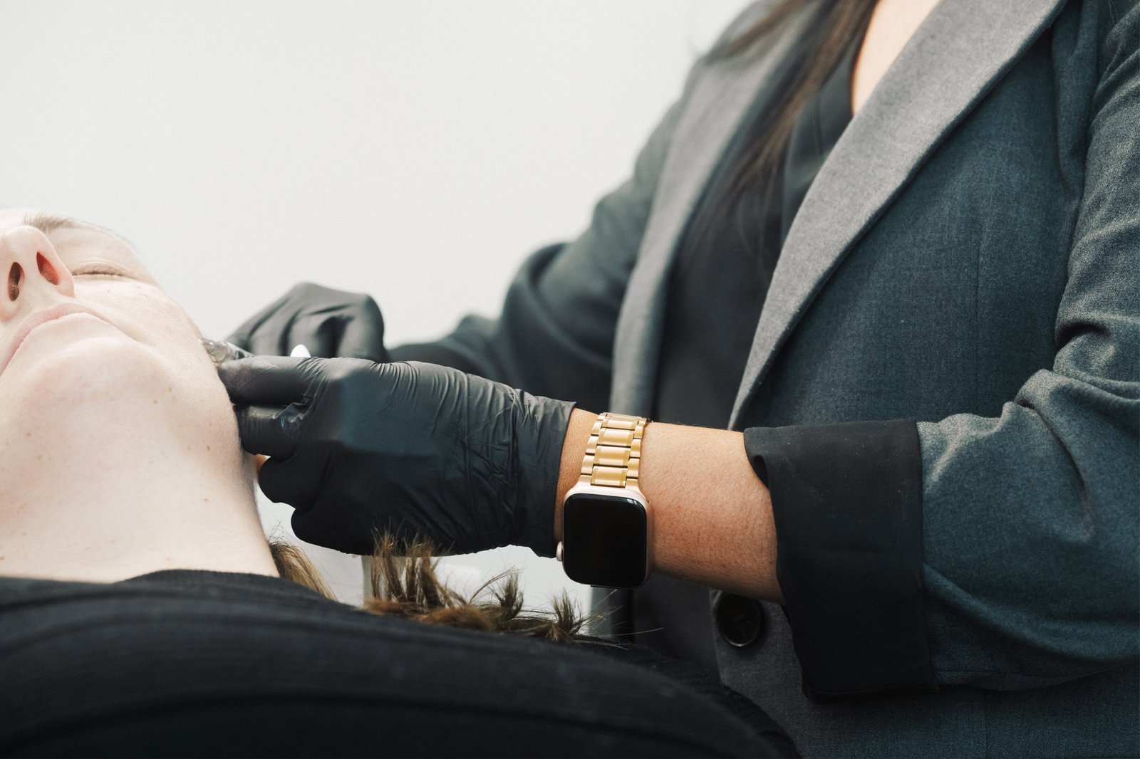 Dr Lauren injecting skin booster in a patient's face.