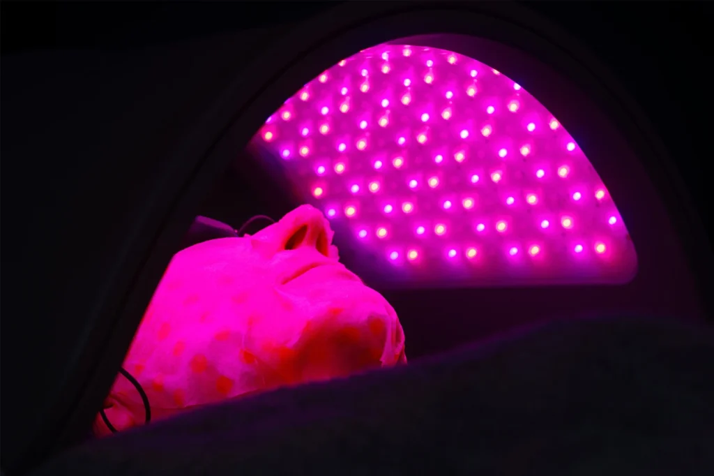 A patient getting LED light treatment.