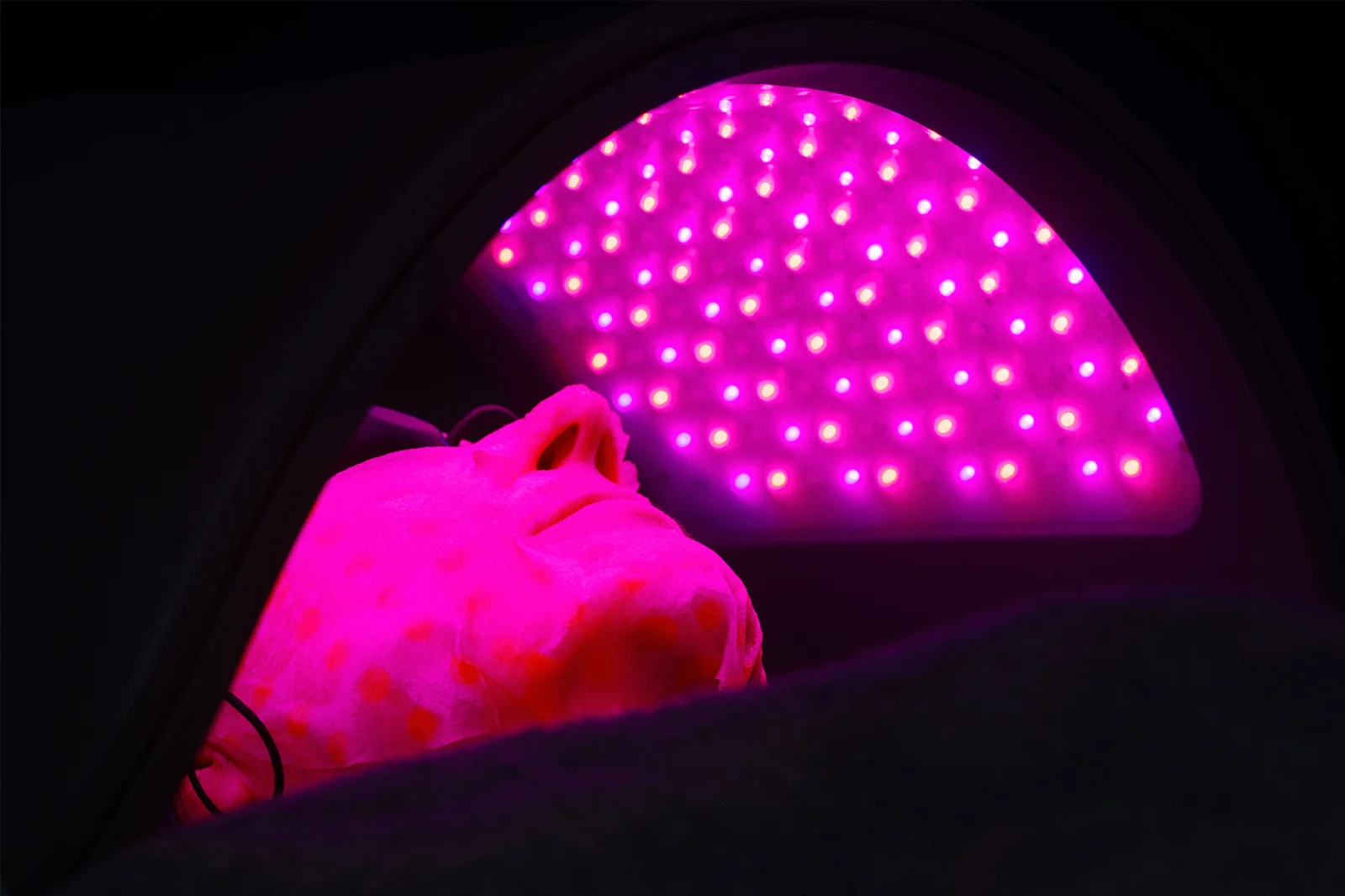 A patient getting LED light treatment.