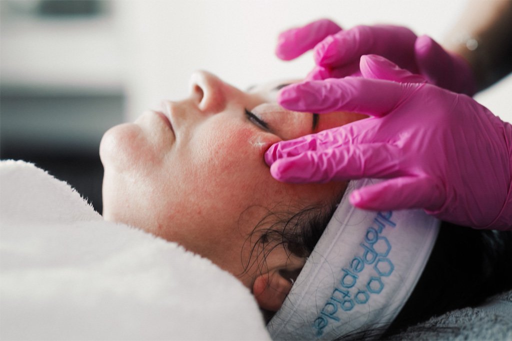 A Skin Therapist at Dr Lauren's clinic treating a patient with HydroPeptide products including their SPF.