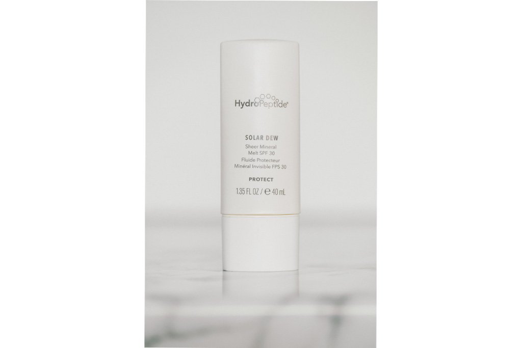 A bottle of HydroPeptide's Solar Dew sheer mineral SPF 30 sunscreen.