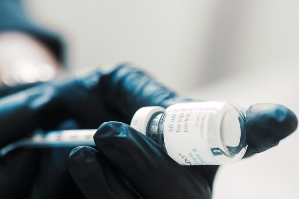 Dr Lauren preparing a syringe with Botox to be used on a patient's face.