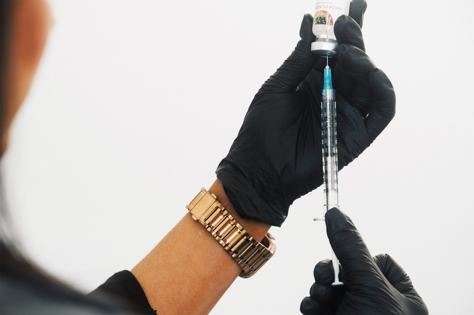 Dr Lauren preparing a syringe with skin booster Neofound to be used on a patient's face.