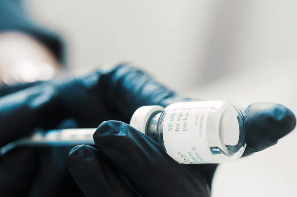 Dr Lauren preparing a syringe with Botox to be used on a patient's face.
