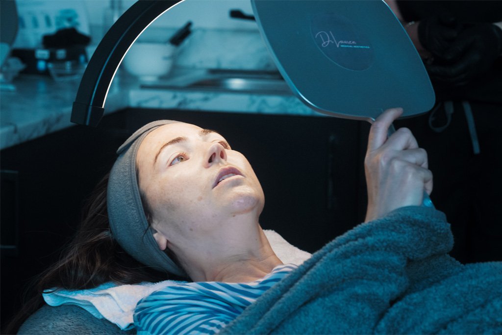 A patient checking her skin after a treatment at Dr Lauren's clinic.