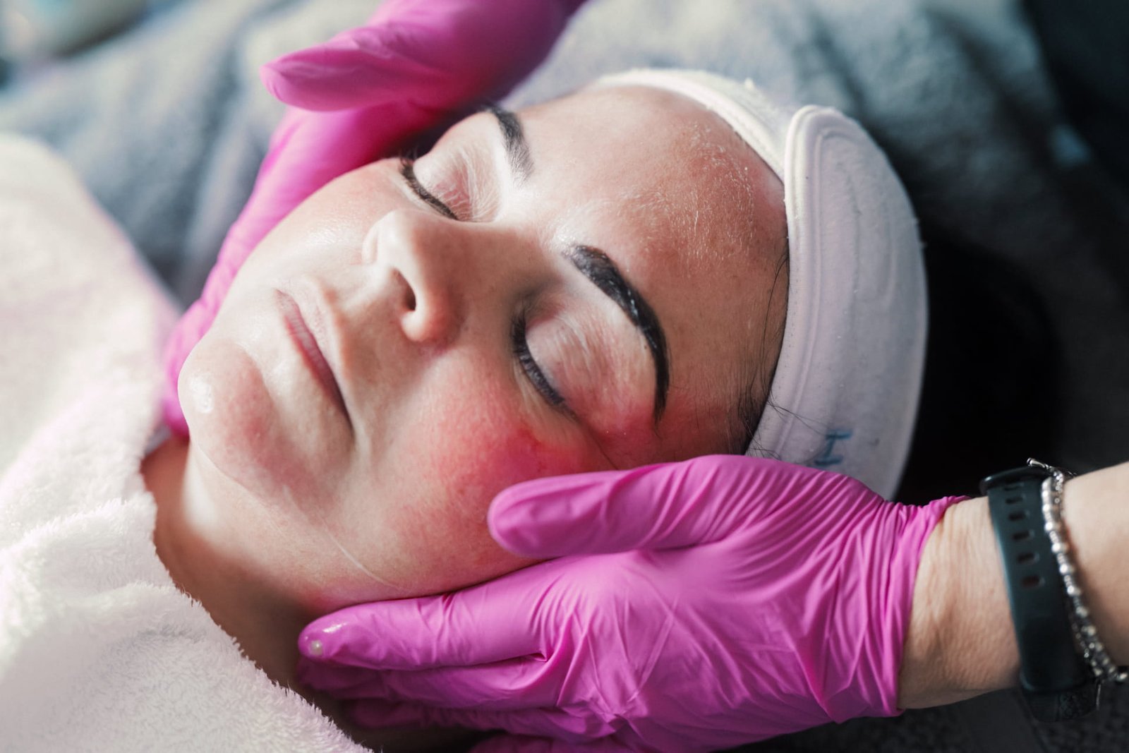 A Skin Therapist at Dr Lauren’s clinic giving a facial to a patient using medical-grade skincare products.