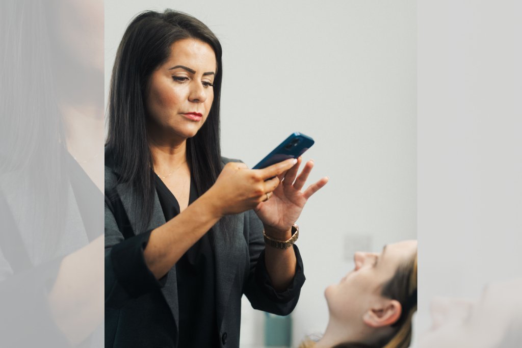 Dr Lauren taking a picture of her patient's face to tell her which areas can benefit from a treatment.