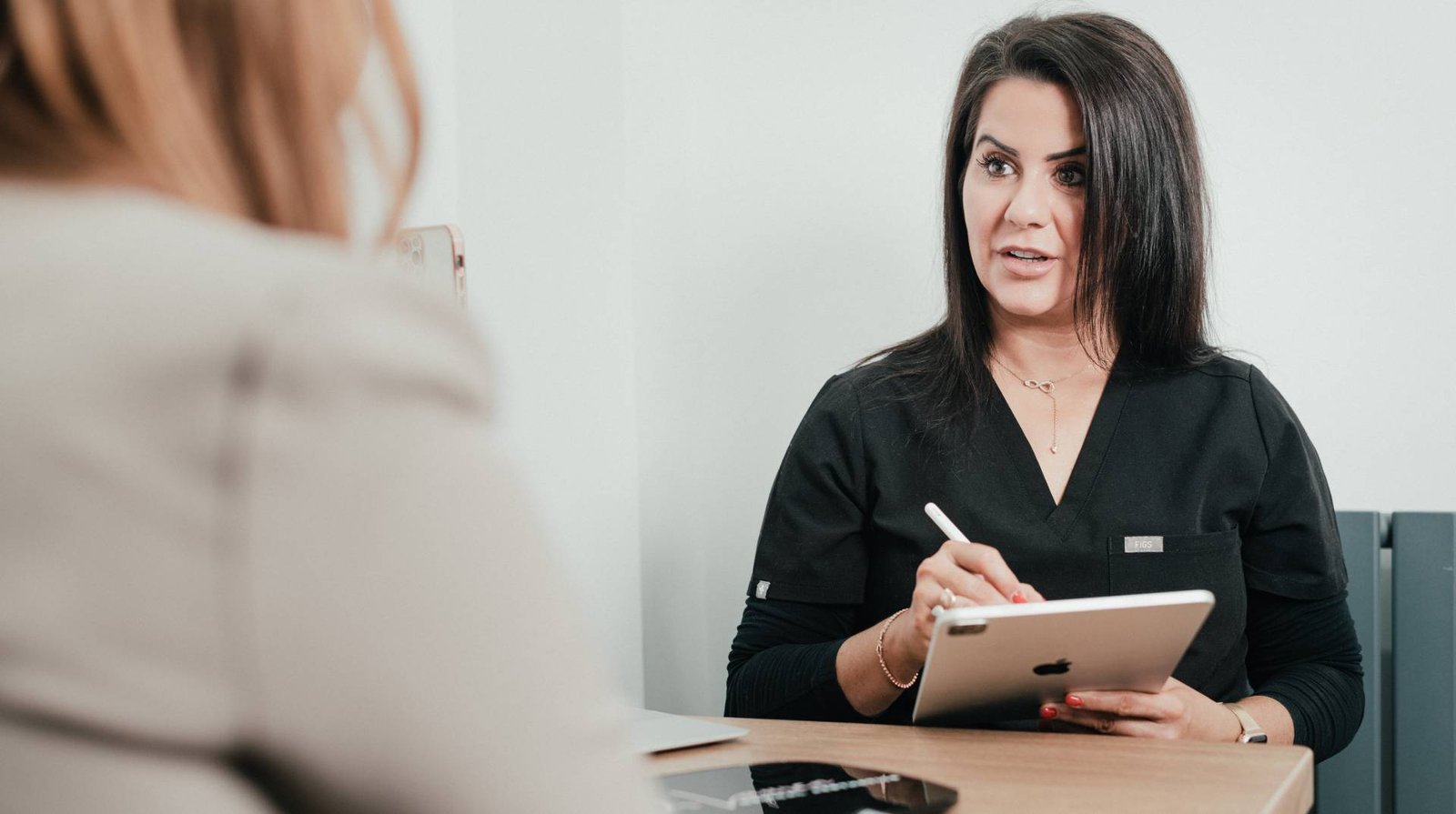 Dr Lauren consulting and guiding a patient.
