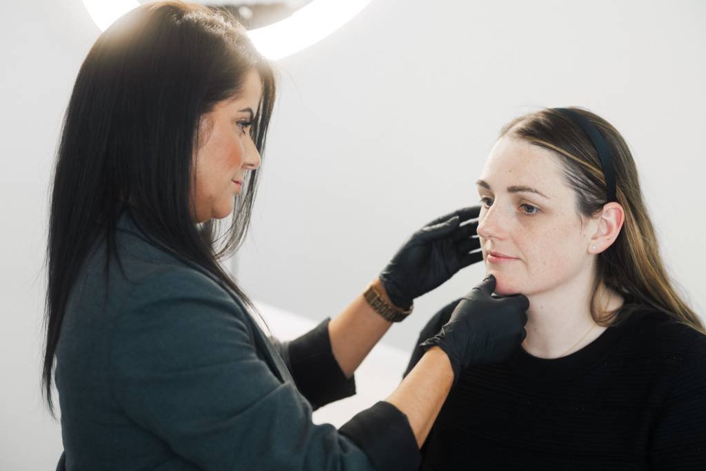 Dr Lauren assessing a patient's skin.