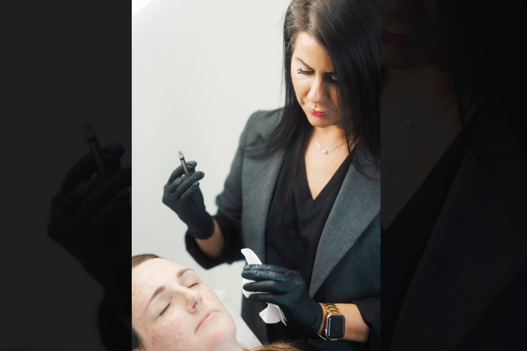Dr Lauren administering dermal filler to a patient's face.